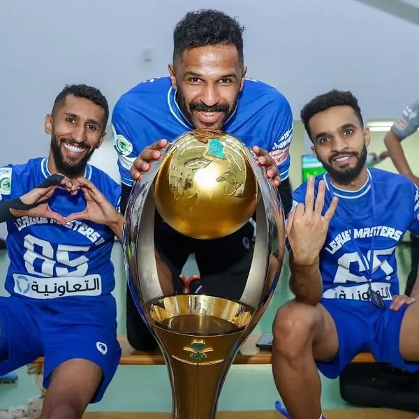 Mohammed Al-Owais with Saudi Professional League trophy with teammates Salman Al-Faraj and Mohammed Al Break