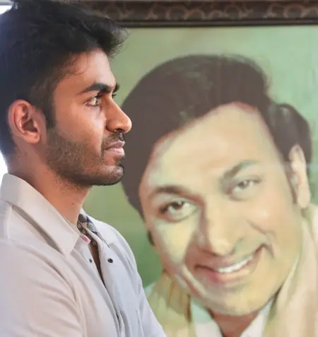 yuva rajkumar with a poster of his grandfather